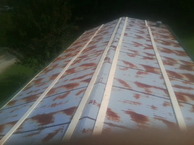 Rusted metal roof panels with new wood purlins before replacement — Storm Damage Roof Repair in Galvin by Roofing Brothers